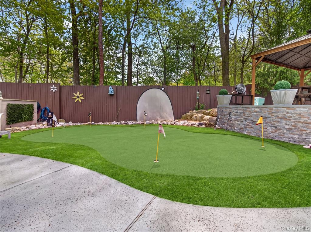 Backyard putting green with multiple flags